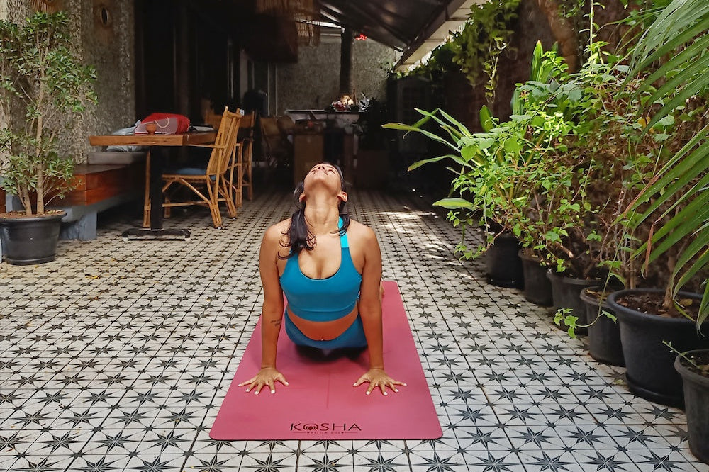 Yoga Teacher on pink and red mat by kosha yoga co 