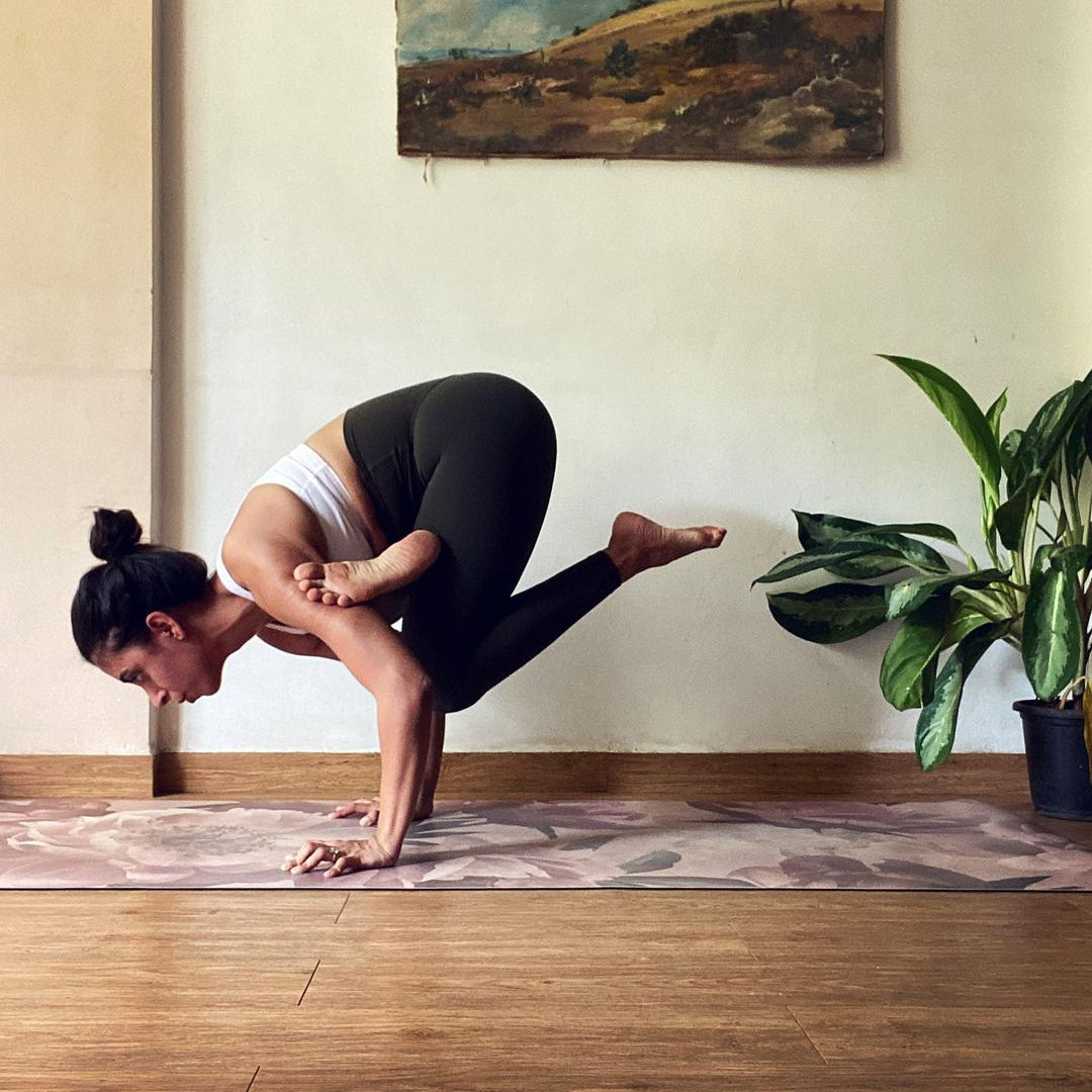 yoga teacher on floral yoga mat