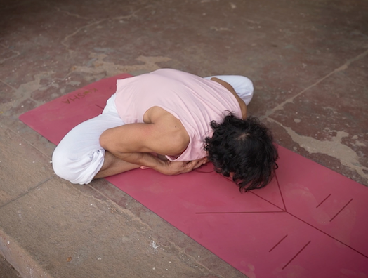 man. practising yoga on pink colour yoga mat