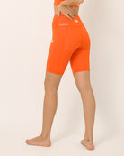 Orange squat proof shorts for yoga and sports bra yoga set by kosha yoga co