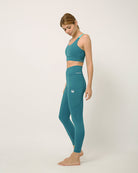 Green yoga pants and sports bra for yoga, gym, workouts, running made by kosha yoga co from recycled materials