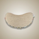 Half-moon shaped pillow with decorative edge on a beige background