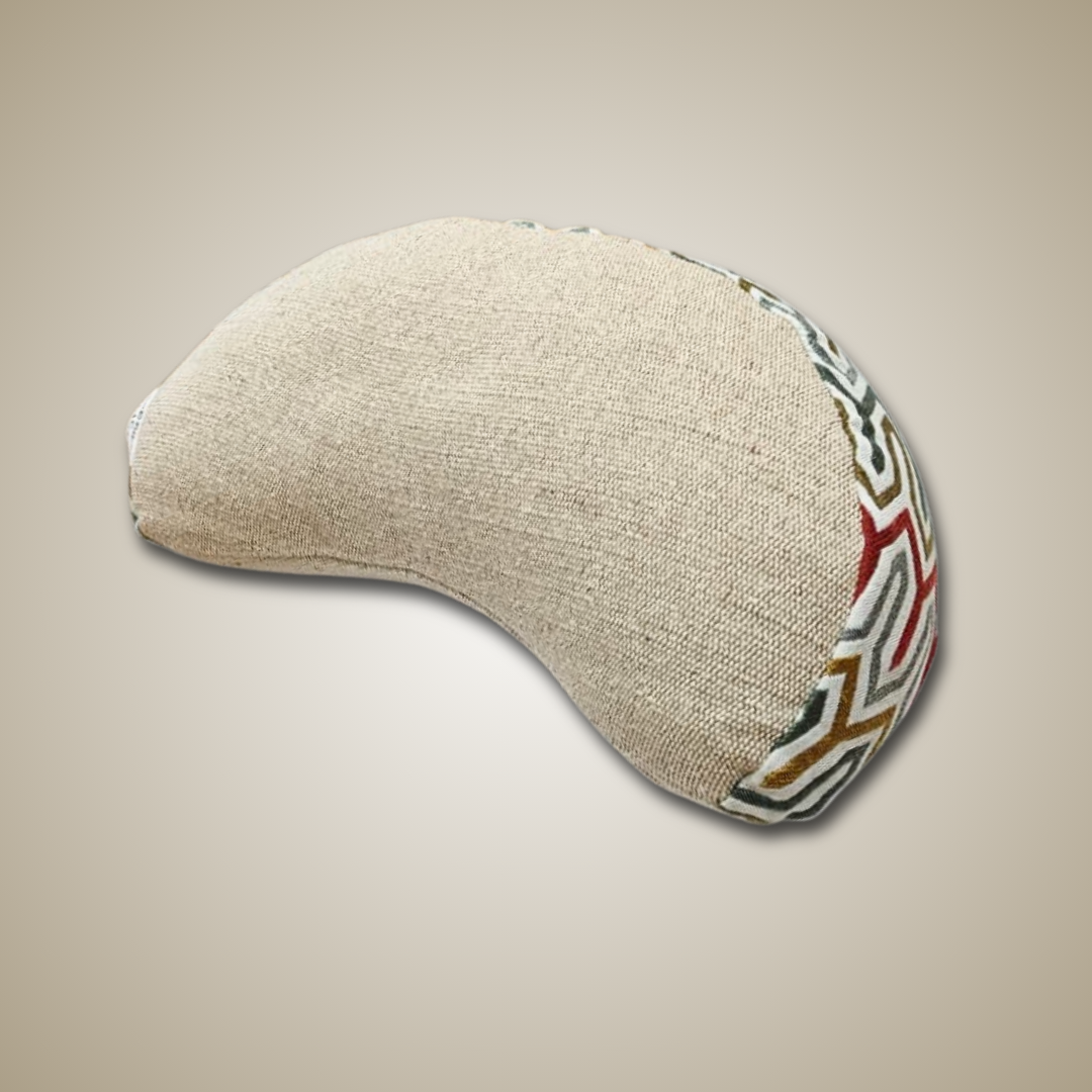 Eye pillow with a textured surface and colorful pattern on a beige background