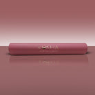 Pink yoga mat with 'KOSHA YOGA CO' branding on a matching pink background