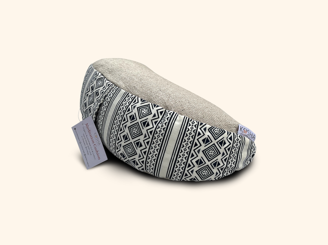 A meditation cushion with a geometric pattern in black and white colors, designed to support the user's back and hips during meditation.