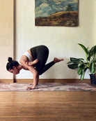 yoga teacher on floral yoga mat