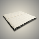 Ivory and black Kosha foldable meditation cushion lying open, showing its quilted cotton top