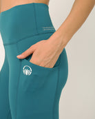 Green knee length shorts with pocket for yoga and sports bra yoga set by kosha yoga co