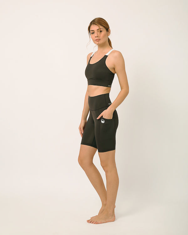 Black Sustainable activewear made out of recycled materials by Kosha Yoga Co. Squat proof, stretchable biker shorts for yoga, gym, workouts, running.