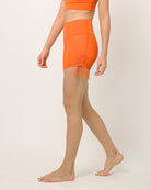Orange moisture wicking shorts with adjustable length by kosha yoga co
