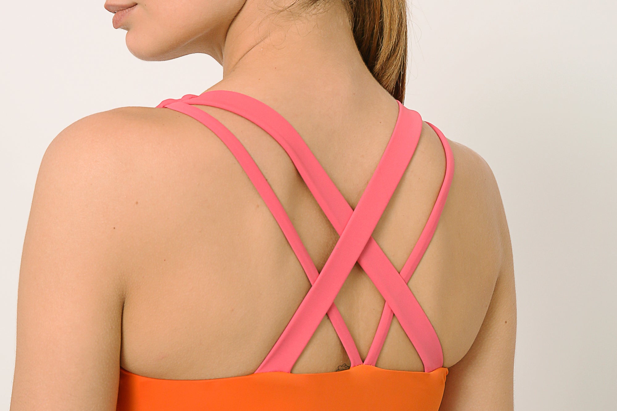 Orange and pink sports bra co-ord set with contrast straps for yoga, gym, workouts, running made by kosha yoga co from recycled materials