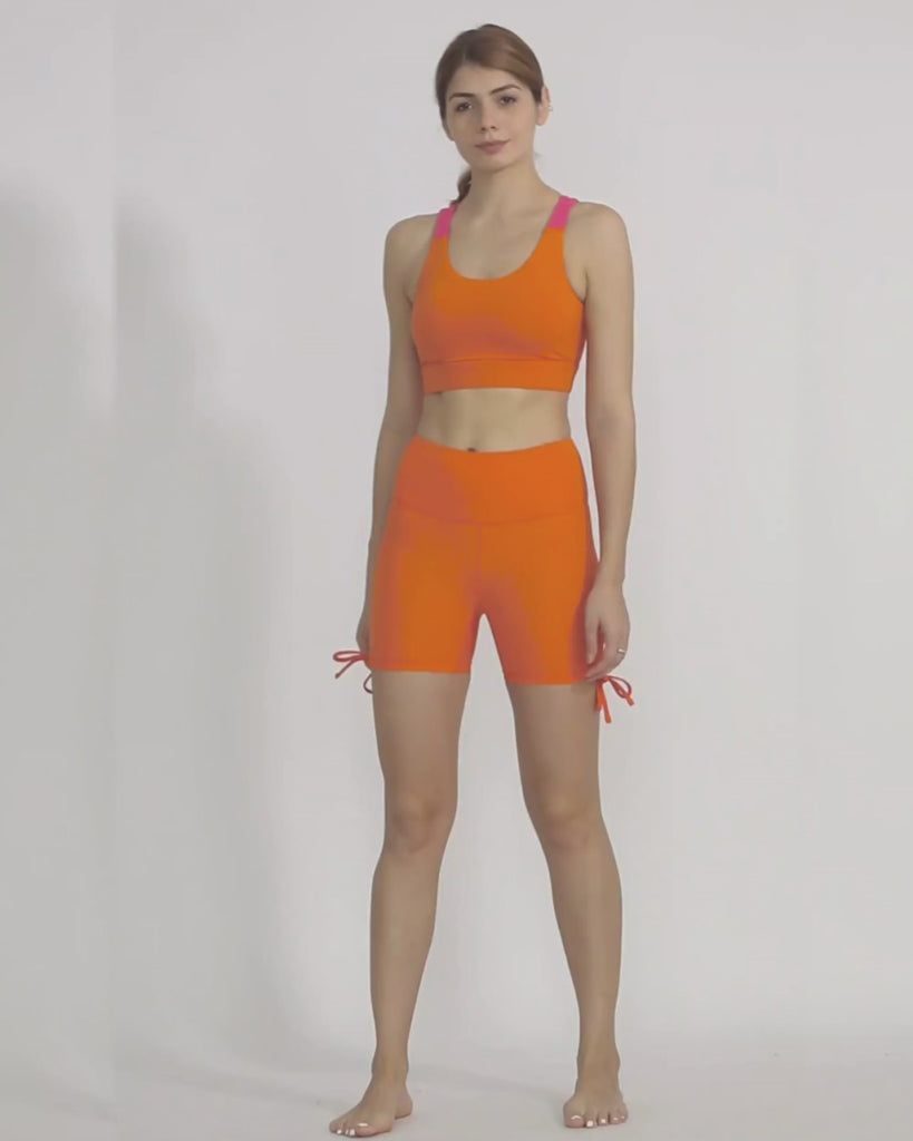 Orange Yoga shorts and sports bra co-ord set by kosha yoga co from recycled materials