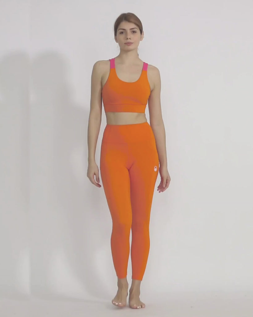Orange yoga pants and sports bra co-ord set by kosha yoga co from recycled materials